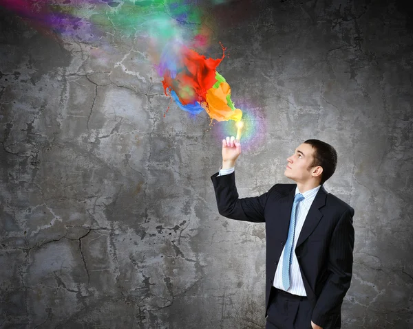 Businessman and colorful splashes — Stock Photo, Image