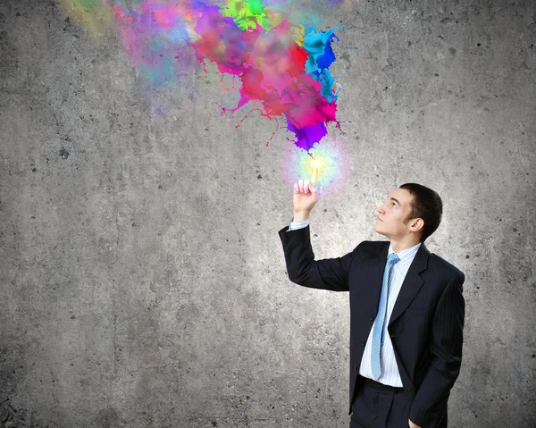 Businessman and colorful splashes — Stock Photo, Image