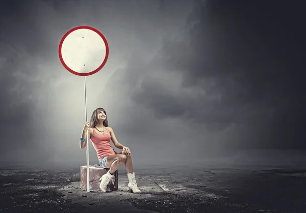 Girl traveler sitting on suitcase — Stock Photo, Image