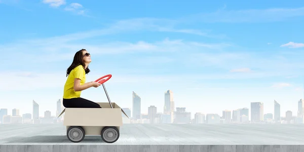 Woman riding in carton box — Stock Photo, Image