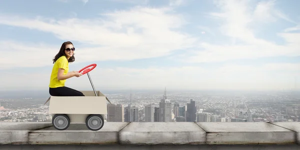 Woman riding in carton box — Stock Photo, Image