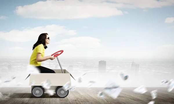 Woman riding in carton box — Stock Photo, Image