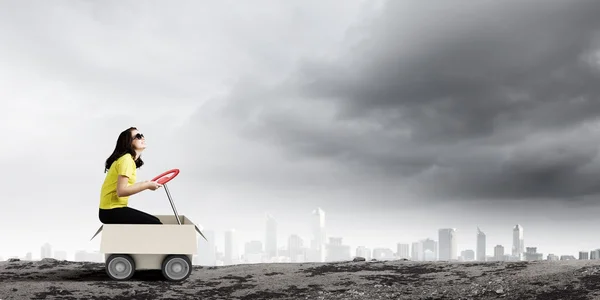 Woman riding in carton box — Stock Photo, Image