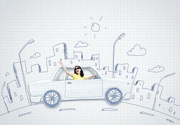 Woman riding car made of paper — Stock Photo, Image