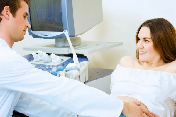 Pregnant woman examined by doctor — Stock Photo, Image