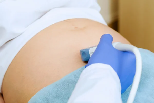 Pregnant woman examined by doctor — Stock Photo, Image