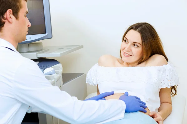 Pregnant woman examined by doctor — Stock Photo, Image