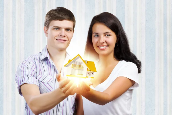 Casal segurando modelo de casa — Fotografia de Stock