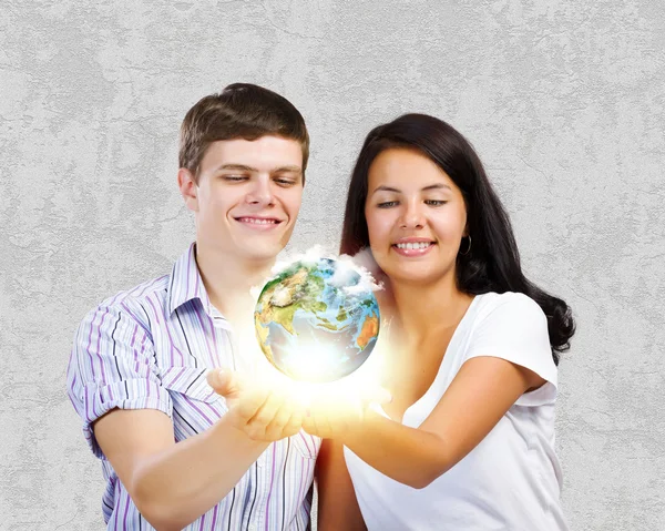 Couple holding earth planet — Stock Photo, Image