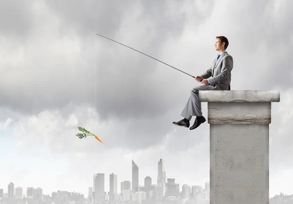 Businessman fishing with rod — Stock Photo, Image