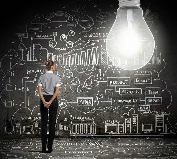 Businesswoman with bulb — Stock Photo, Image