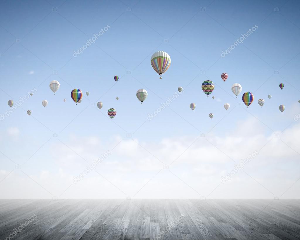 Colorful balloons flying high in sky