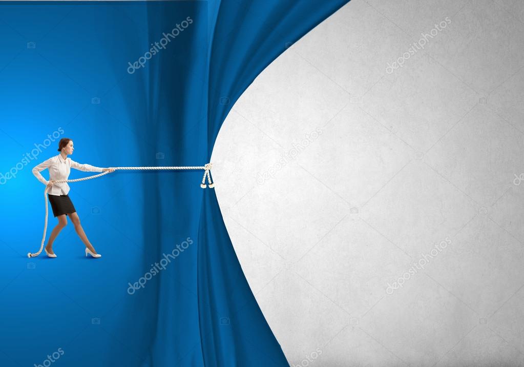 Businesswoman pulling curtain with rope
