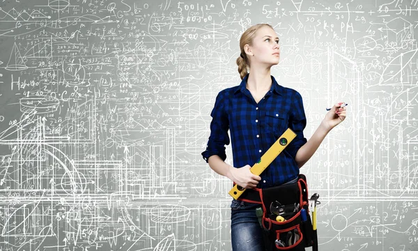 Woman mechanic with ruler in hand — Stock Photo, Image