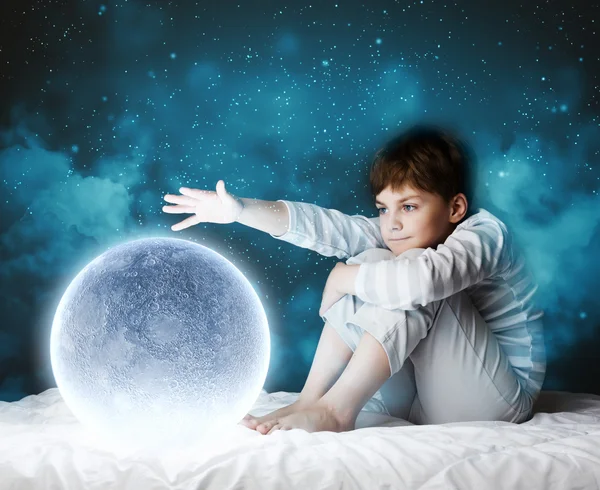 Boy sitting in bed — Stock Photo, Image