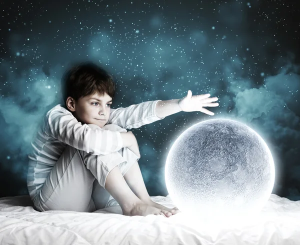 Boy sitting in bed — Stock Photo, Image