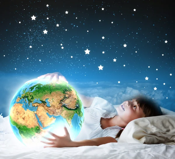 Girl lying in bed with moon Earth planet — Stock Photo, Image