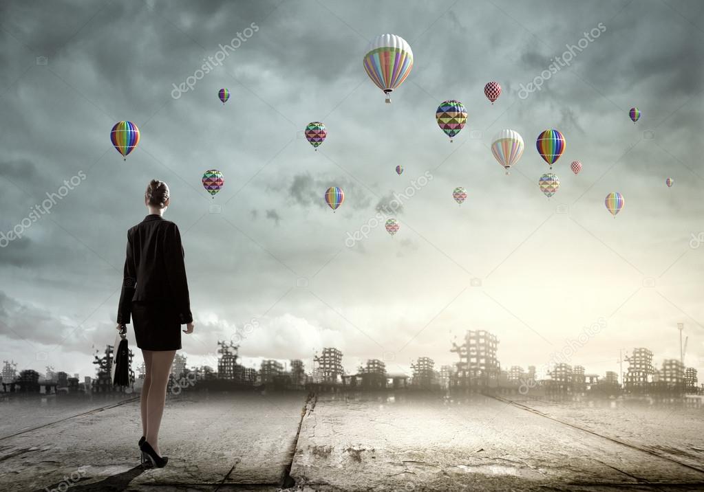 Businesswoman looking at balloons