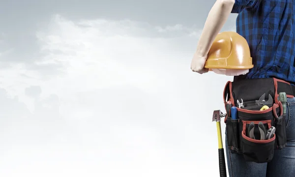 Woman mechanic with yellow helmet