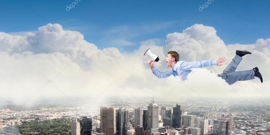 Young businessman with megaphone