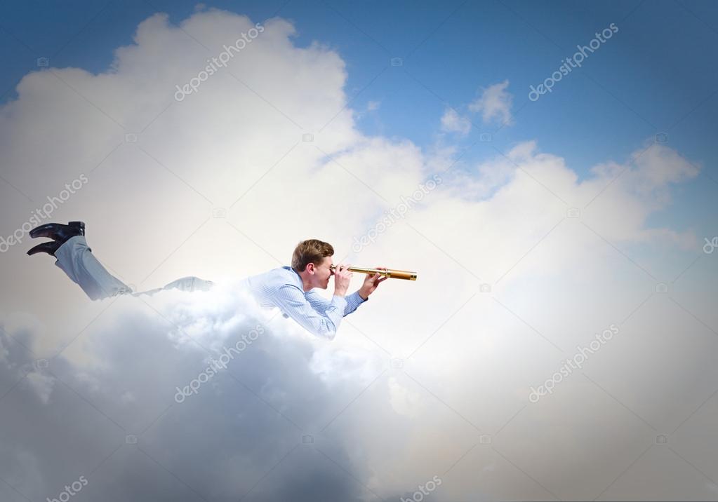 Young businessman flying in sky