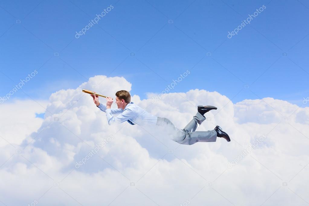 Young businessman flying in sky