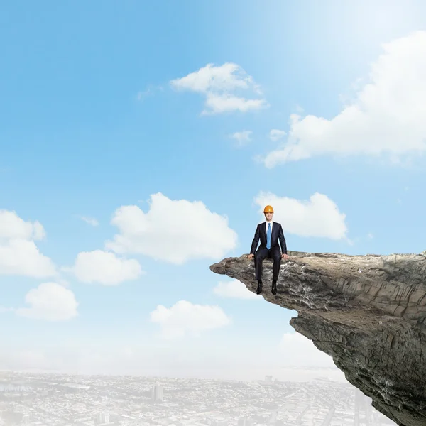 Businessman on edge of mountain rock — Stock Photo, Image