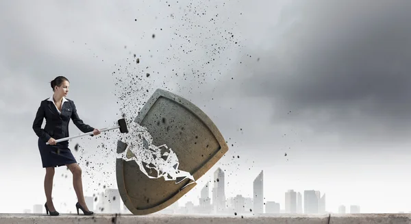 Businesswoman crashing stone shield — Stock Photo, Image