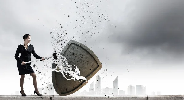 Businesswoman crashing stone shield — Stock Photo, Image