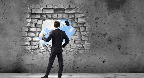 Businessman with hammer in hands