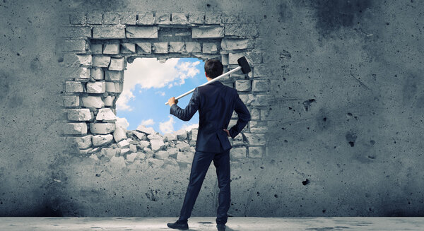 Businessman with hammer in hands