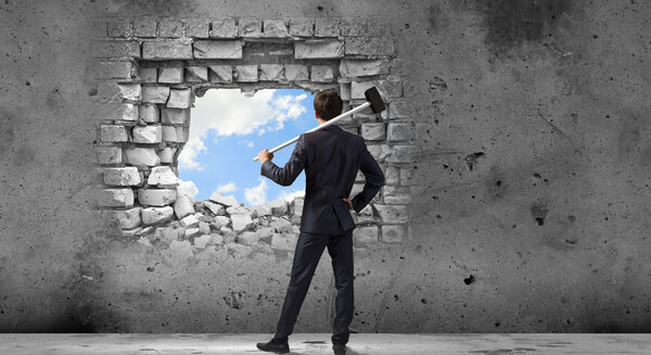 Businessman with hammer in hands