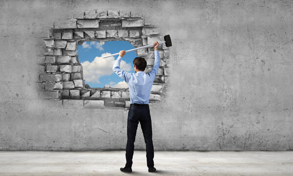 Businessman with hammer in hands