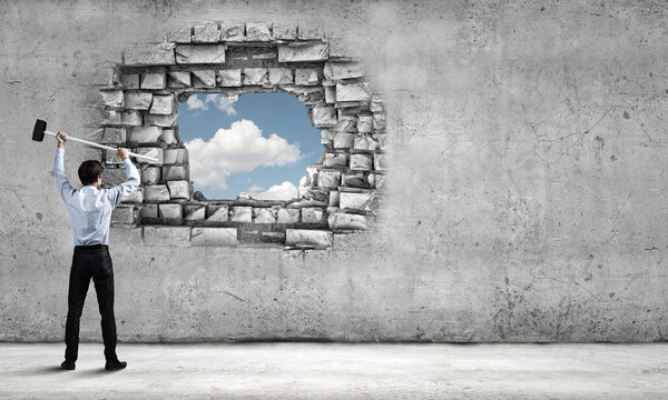 Businessman with hammer in hands