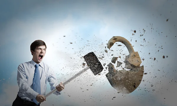 Businessman crashing stone lock — Stock Photo, Image