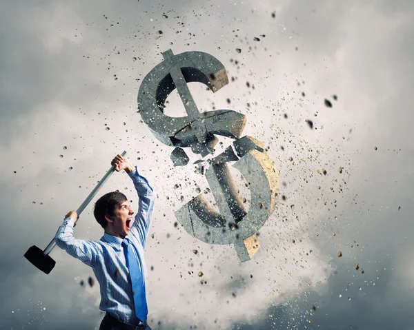 Businessman crashing stone dollar symbol — Stock Photo, Image