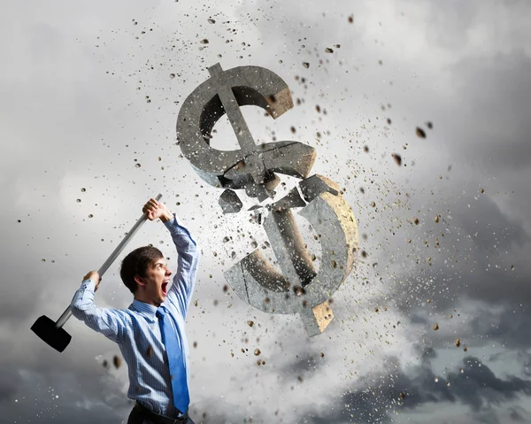 Businessman crashing stone dollar symbol — Stock Photo, Image