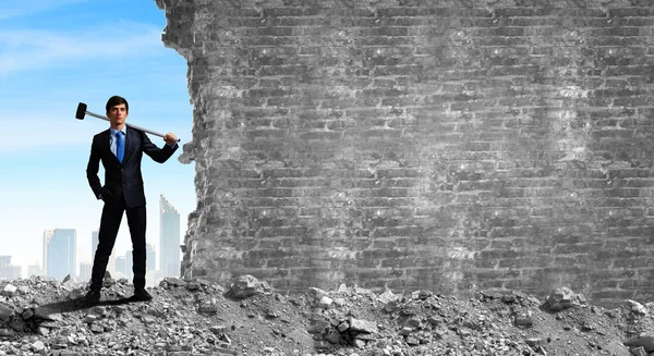 Businessman with hammer in hands — Stock Photo, Image