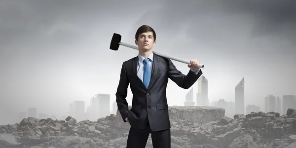 Businessman with hammer in hands — Stock Photo, Image