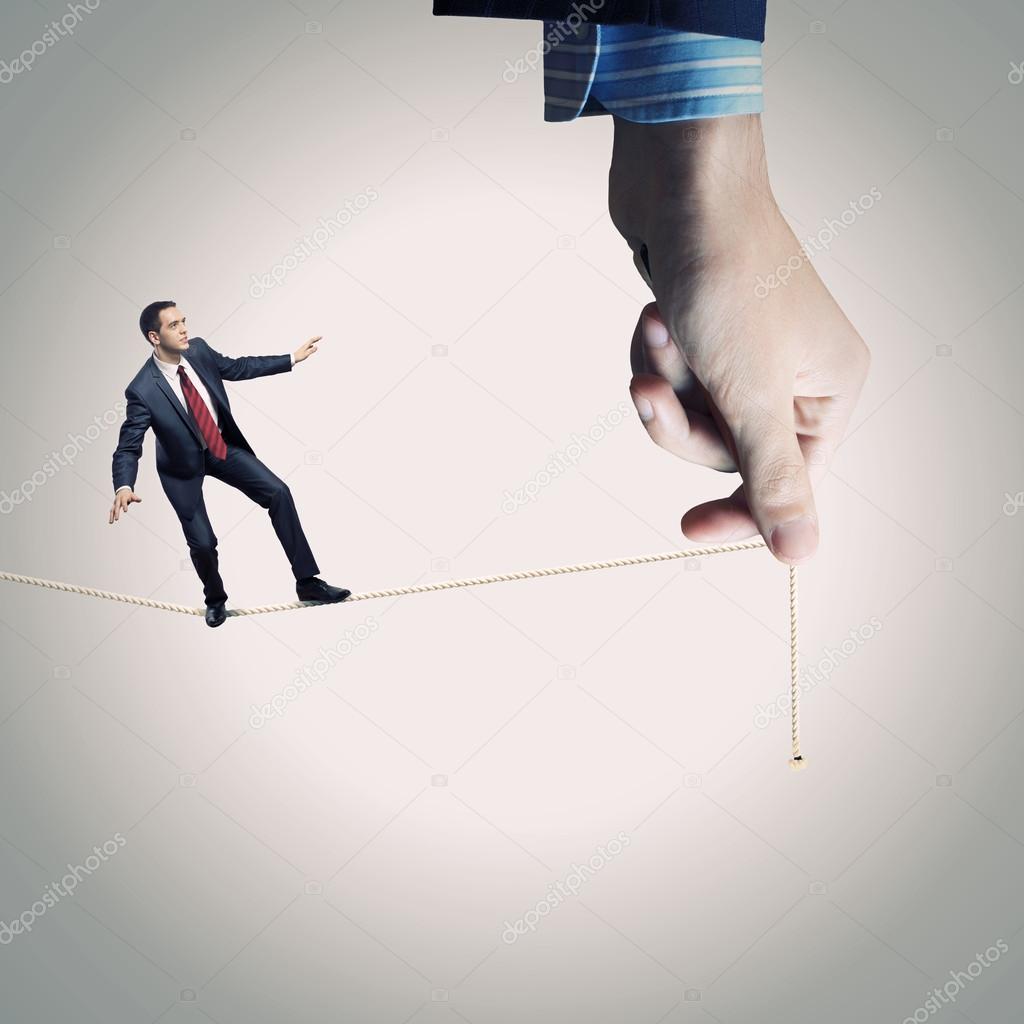Businessman balancing on rope