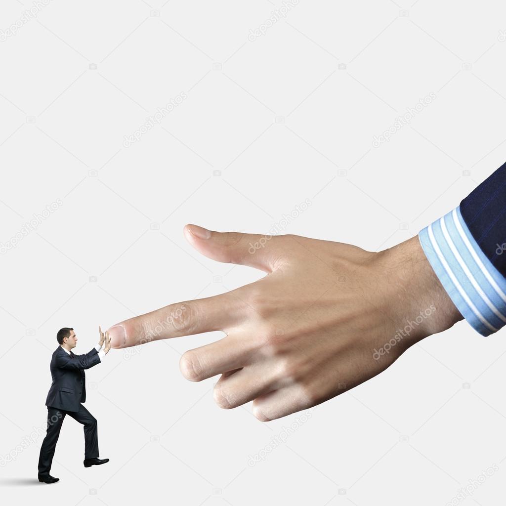 Businessman pointing at miniature of man