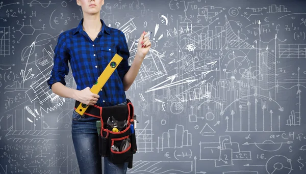 Woman mechanic with ruler in hand — Stock Photo, Image