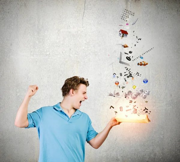 Man holding opened book with icons — Stock Photo, Image