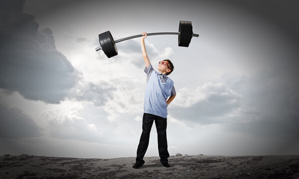Boy lifting barbell above head