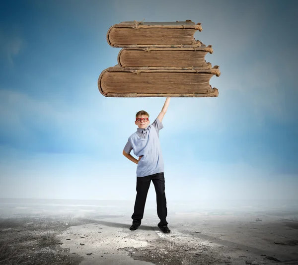 Schoolboy holding books — Stock Photo, Image