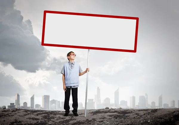 Boy holding blank banner — Stock Photo, Image