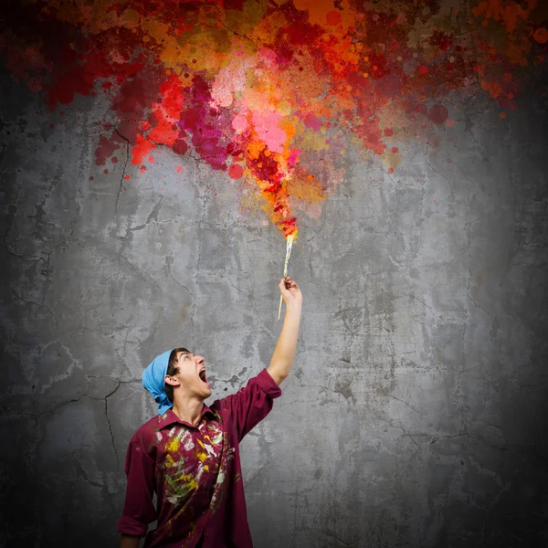 Handsome man painter with brush — Stock Photo, Image