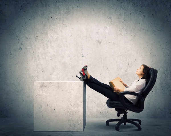 Businesswoman sitting with book — Stock Photo, Image