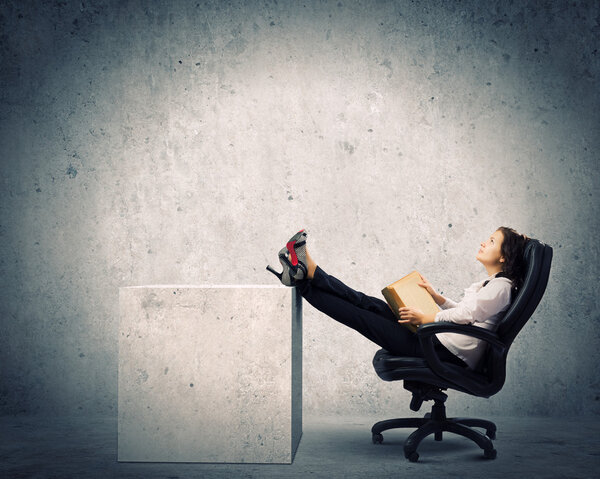 Businesswoman sitting with book