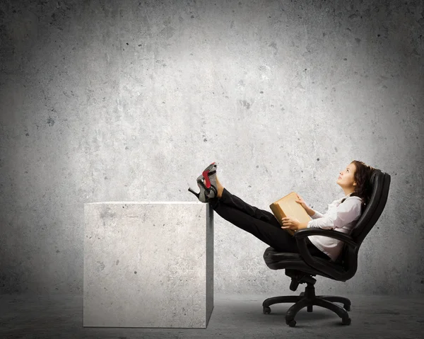 Businesswoman sitting with book — Stock Photo, Image